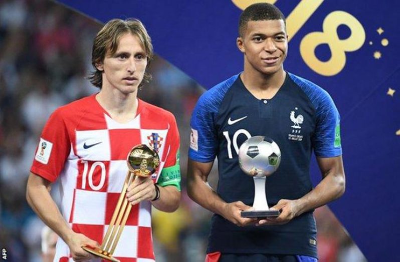 Luka Modric (left) poses with the Golden Ball with Kylian Mbappe holding his Young Player Award