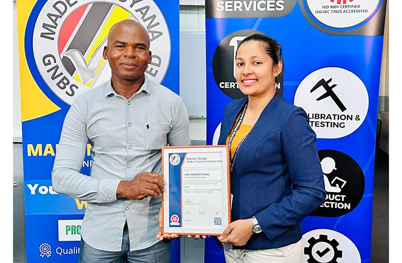 Proprietor and CEO of Luke’s Manufacturing, Mr. John Luke receives the certificate from GNBS Technical Officer, Ms. Rosmarie Liliah.