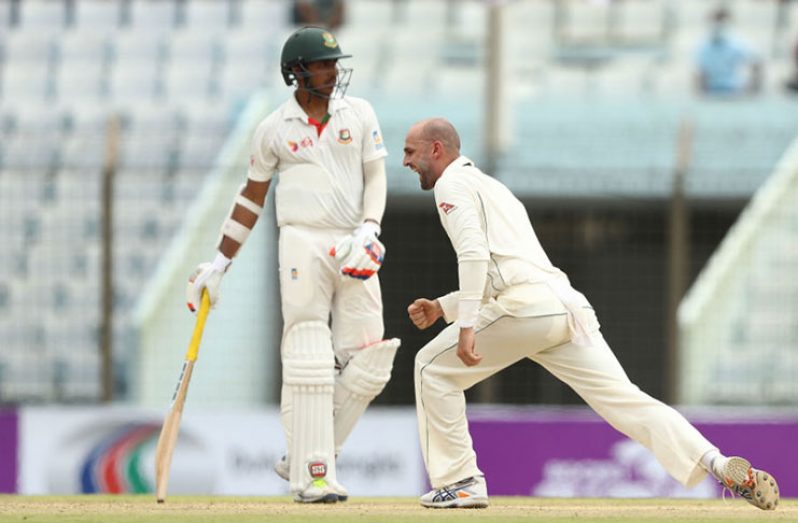 Lyon takes the new ball and traps Tamim Iqbal in front for 9. The off-spinner ends the day with five for 77. (Getty Images)
