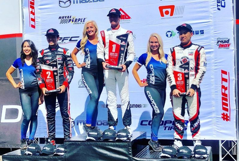 Calvin Ming stands on the third step of the podium following race one of the Cooper Tyres Mazda USF2000 series in Portland Oregon. He was promoted to second after Igor Fragga (Extreme left) was handed a 30-second penalty.