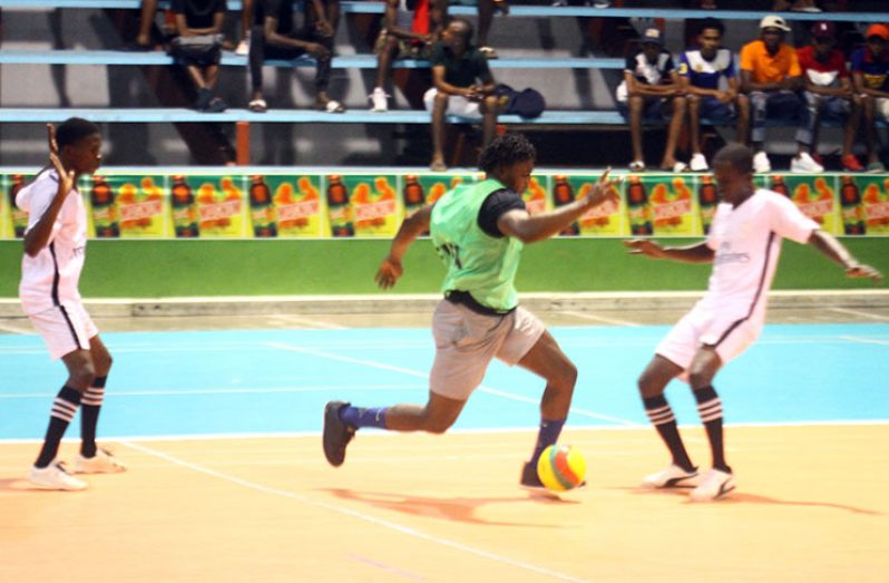 Action in the Magnum ‘Mash’ Futsal cup between North East La Penitence (in white) and Good-Life.