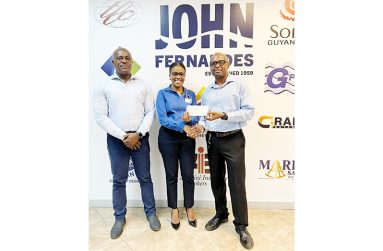 JFL’s Office Manager Alisa Maxwell hands over cheque to GAPLF’s Treasurer, Maxwell Denny, in the presence of its president, Franklin Wilson