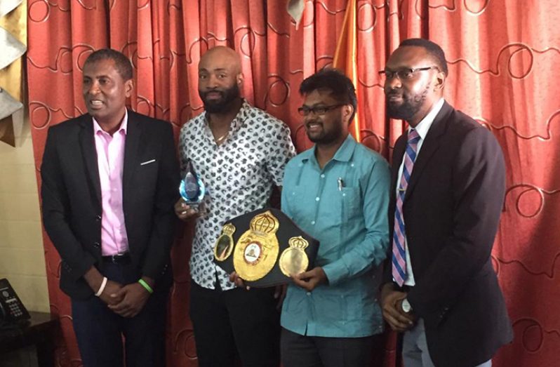 Lennox ‘Too Sharp’ Allen flanked by Deputy Mayor Alfred Mentore (first from left), Mayor Ubraj Narine and Director of Sport, Christopher Jones. (Rawle Toney photo)