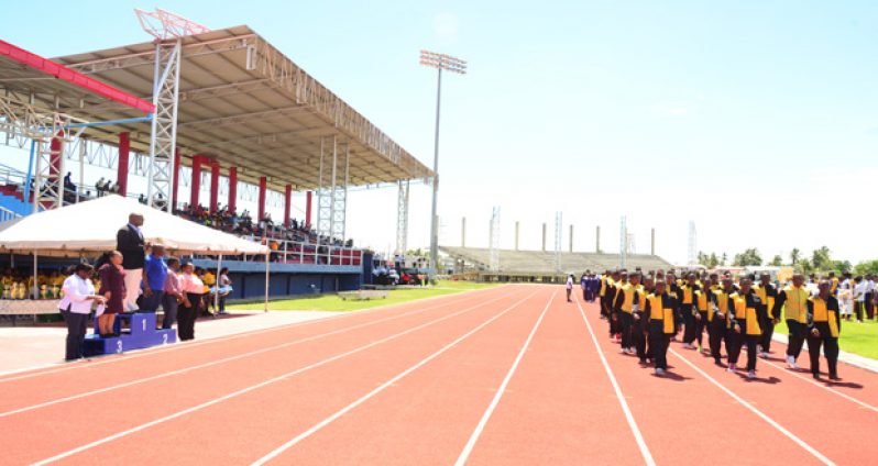 CEO Olato Sam takes the salute at the march past of athletes.(Adrian Narine photo)