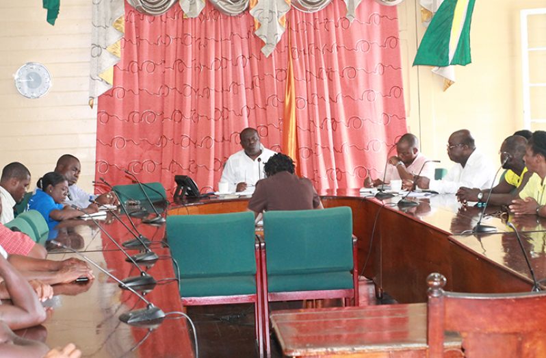 Town Clerk Royston King (at centre) and leader of the Guyana Local Government Officers Union, Carvil Duncan ( fourth from right) sit in a meeting with city officials.