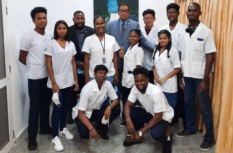 Ambassador Halim Majeed (centre) flanked by medical students at the Latin American School of Medicine (ELAM)