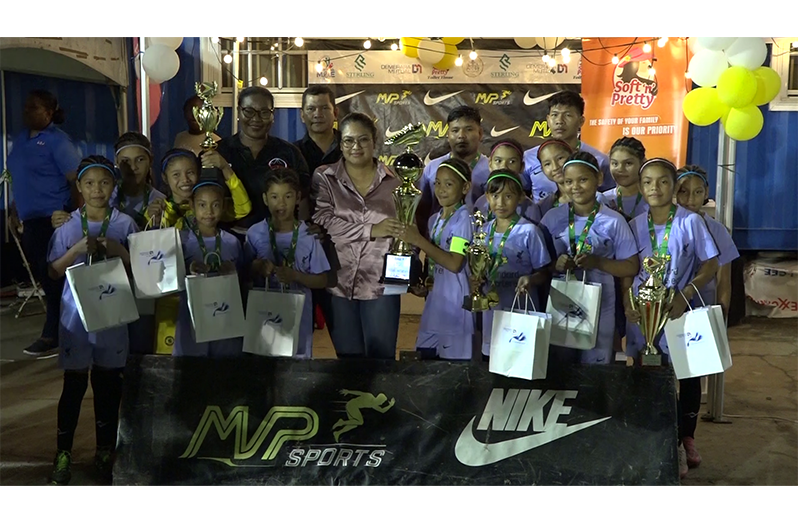Minister of Amerindian Affairs Sarah Brown Presenting Santa Rosa with trophy in the presence of MoE Deputy CEO Marti De Souza and Petra Secretary Jackie Boodie