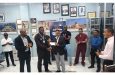 Nazar Mohamed, CEO of Mohamed’s Enterprise presents the GY$1M sponsorship cheque to Mixed Martial artist, Carl Ramsay, flocked by club president and other executives of the GMMAF (Clifton Ross photo)