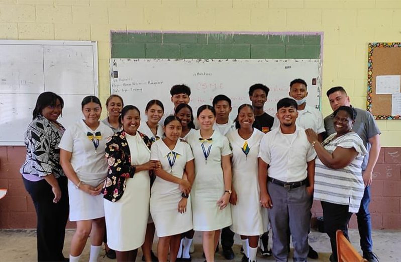 Zeeburg Secondary School’s acting Head of Department for Business, Anella Bissessar with the students at the Belmopan Comprehensive High School