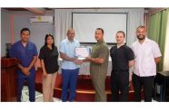 Minister of Health, Dr. Frank Anthony presents a certificate to one of the participants