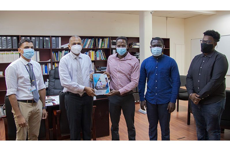 Health Minister Dr. Frank Anthony (second from left) receiving one of the reports from Managing-Director of SASOD, Joel Simpson (third from left).  Also in the photo are Programme Manager of the National AIDS Programme Secretariat, Dr. Tariq Jagnarine (far left); SASOD Guyana Human Rights Coordinator Kobe Smith (second from right) and Community Representative on the Guyana Global Fund Country Coordinating Mechanism, Christopher France (far right).