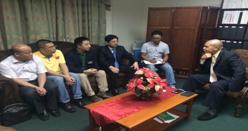 Public Health Minister Dr. George Norton meeting the five-member Chinese medical specialist team