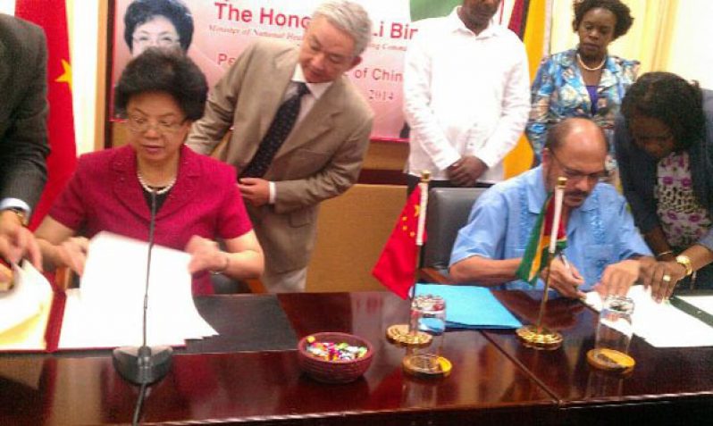 China's Health Minister, Li Bin and Guyana's Health Minister, Dr Bheri Ramsaran sign the MOU for the Medical House of Science