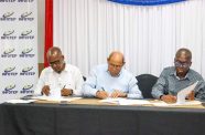 Minister of Labour, Joseph Hamilton, signs the MoU alongside other personnel from the National Institute for Technical and Vocational Training (INFOTEP)