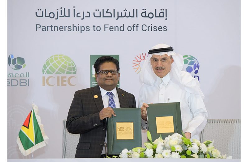 Dr. Ashni Singh and IsDB President Dr. Muhammad Al Jasser shortly after signing the watershed MoU in Saudi Arabia on Friday (Ministry of Finance photo)