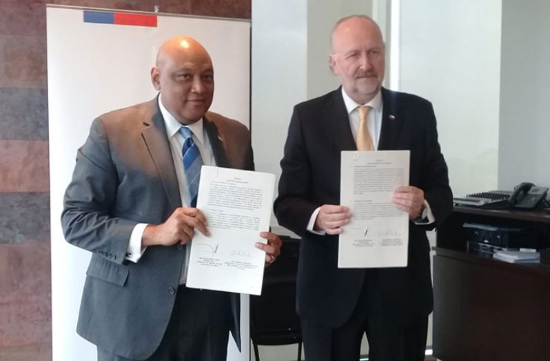 Minister of Natural Resources Raphael Trotman (left) and Chile´s Minister of Mining Baldo Prokurica following the signing of the MOU