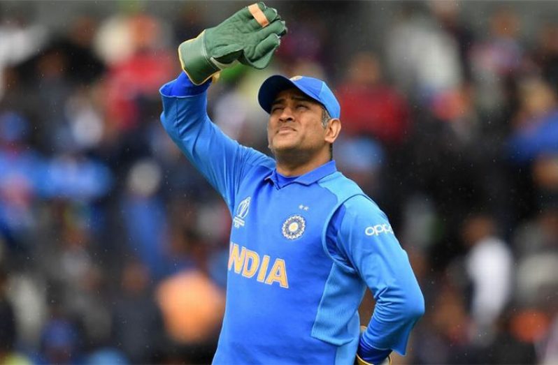 MS Dhoni looks up as light drizzle continues. (Getty Images)