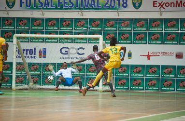 Guyana’s Andrew Murray, caught by Chronicle Sports photographer Samuel Maughn, blasting in the opening goal of the game during his side’s 4 – 0 win at the Cliff Anderson Sports Hall.