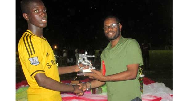 Most Valuable Player Donovan Francis at left collecting his spoils from Regional Chairman Sharma Solomon..