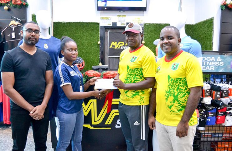 MVP Sports Sales Representative Ms Brittany Mathews hands over the sponsorship cheque to GFF’s Brian Joseph in the presence of MVP Sports’ Eon Ramdeo (left) and GFF’s Keeran Williams.