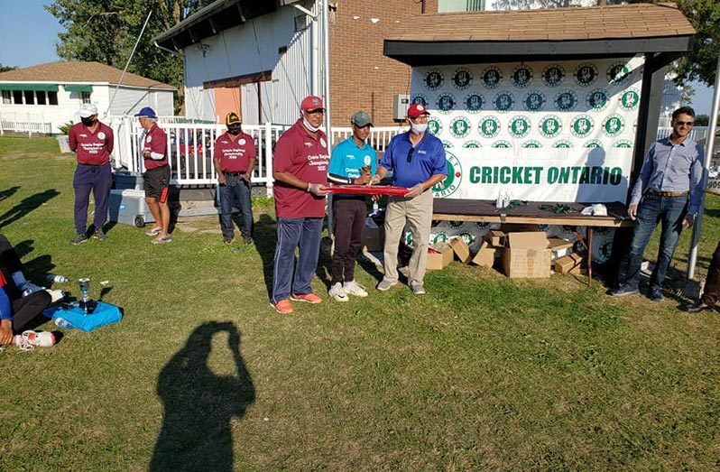 Matthew Nandu (centre) receives his MVP award from Cricket Ontario president Sha Saleem Zafar (right) and vice-president Praim Persaud.