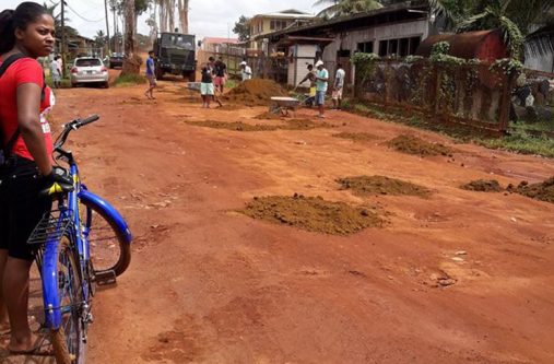 A resident looks on as works were undertaken on the roadway on Sunday.