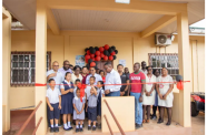 Minister of Health Dr. Frank Anthony, along with residents and staff participating in the ribbon cutting