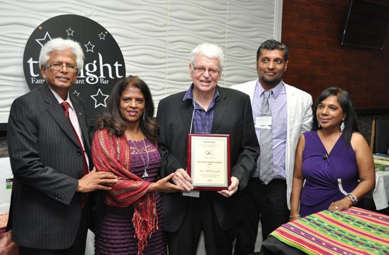 Dr. Ian McDonald (centre) with award. From left are: Ken Singh, Pakaraima president Janet Naidu, vice-president Habeeb Alli, and executive director Shirley Najhram