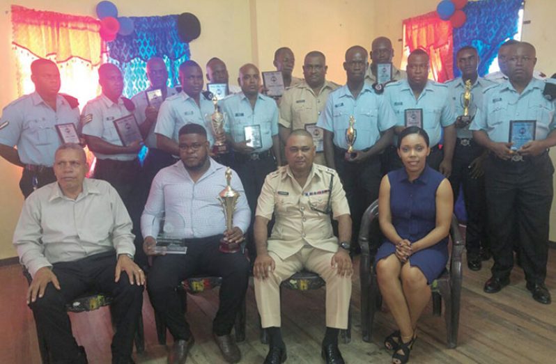 From right seated: Magistrate Crystal Lambert; Divisional Commander Ravindradat Budhram; ‘F’ Division Best Cop, Detective Sergeant Henry; and Regional Chairman Gordon Bradford with other ranks who were awarded for their performance (Rabindra Rooplall Photo)