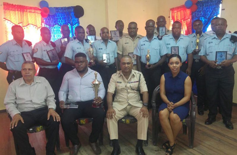 From right seated: Magistrate Crystal Lambert; Divisional Commander Ravindradat Budhram; ‘F’ Division Best Cop, Detective Sergeant Henry; and Regional Chairman Gordon Bradford with other ranks who were awarded for their performance (Rabindra Rooplall photo)