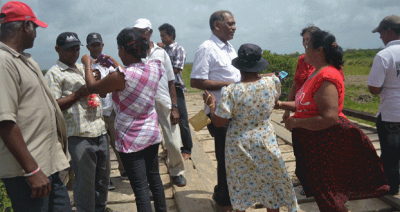 Agriculture Minister, Dr. Leslie Ramsammy engaging Mahaicony Creek residents during a visit there Wednesday.