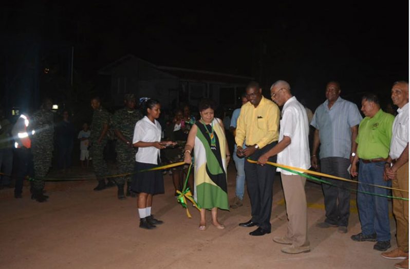 President David Granger assists Minister of Public Infrastructure, David Patterson as he cuts the ribbon to officially declare open the road network. Also in photo are Vice President, Sydney Allicock, Ministers Ronald Bulkan, Amna Ally and Joseph Harmon