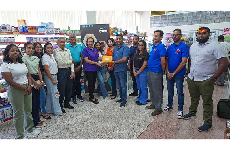 Chief Executive Officer of Mike’s Pharmacy Mala Singh and DCB Treasurer
Vicky Bharosay hold the franchise document in the presence of other representatives of the
two entities
