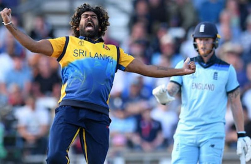 Sri Lanka's Lasith Malinga celebrates taking the wicket of England's Jos Buttler...