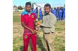Man-of-the-Match Romario Ramdeholl (left) collects his Trophy from Match Referee Shawn Coonjah at the LBI Ground