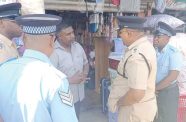 Commander, Senior Superintendent Khalid Mandall, flanked by police ranks speaking to one of the many business owners in Grove, EBD