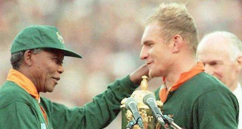 South Africa hosted the Rugby World Cup in 1995, with Francois Pienaar receiving the trophy from Nelson Mandela.