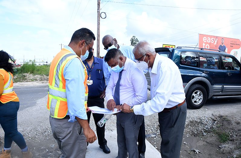 Minister Indar assessing the work plans for the Sheriff/Mandela expansion project. - Adrian Narine Photo