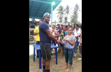 Man-of-the-match in the final, Narendra Mandolall, collects his trophy.