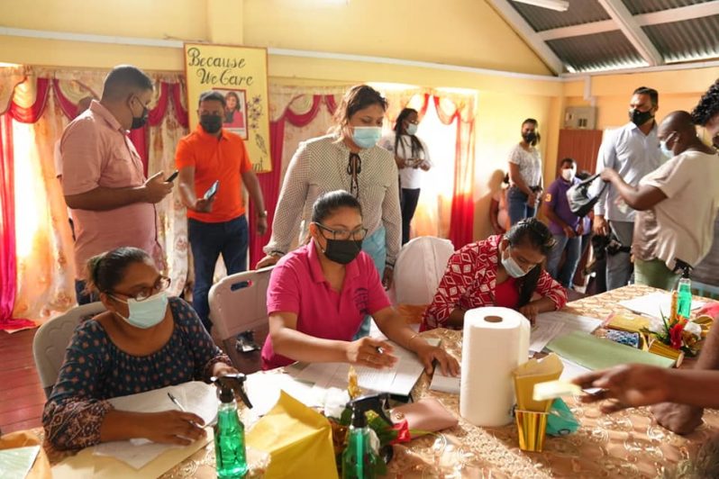 Education Minister Priya Manickchand overseeing distribution of the ‘Because We Care’ cash grant at the Wales Primary School, West Bank Demerara (Ministry of Education photo)