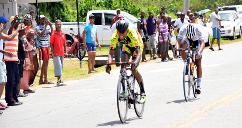 In this Samuel Maughn photo, Raynauth Jeffrey (left) edges Alanzo Greaves to win the 4th annual Mohamed Kadir Memorial 80-mile ‘Ounce of Gold’ cycle road race.