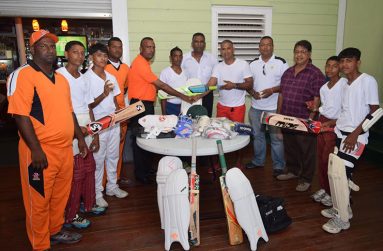 Former Guyana Under-19 player Shameer Sadloo (right) hands over part of the donation to Cold Fusion president Budhnarine Persaud, in the presence of some members of his senior and youth club. Also in picture is Freddie Madray (centre). ECC president Rajesh Singh and Manniram Shew are on Sadloo’s left.