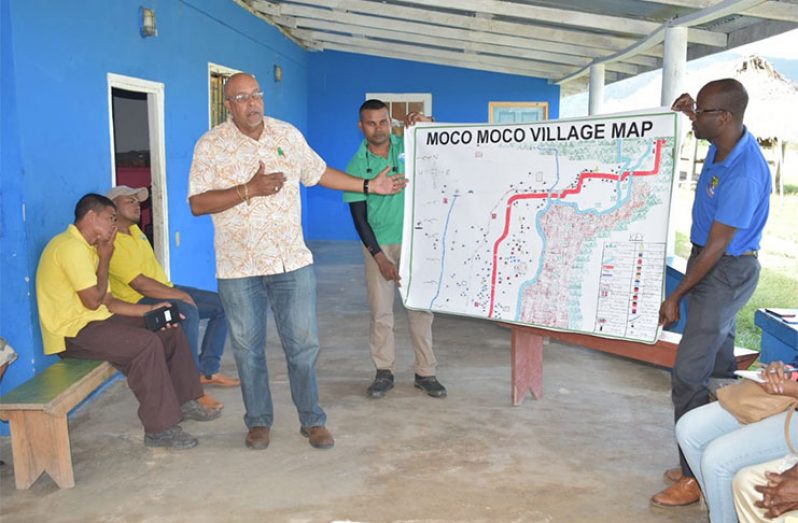 Dr. Van-West Charles points to a map which was designed by Moco Moco Villager & printed through GWI, as he highlights that it will help in the laying of pipelines