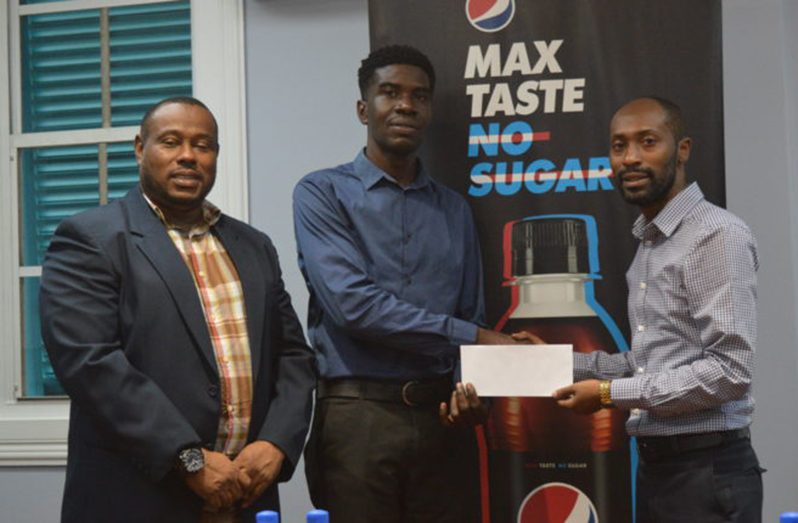 Petra’s representative Mark Alleyne (centre) accepts the sponsorship from Brand Manager Larry Wills in the presence of co-Director of Petra Organisation, Troy Mendonca
