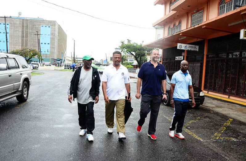 From left: Minister within the Ministry of Social Protection, Keith Scott; Chief Labour Officer Charles Ogle; ILO representative Ariel Pino and another participant, leading the march on Saturday