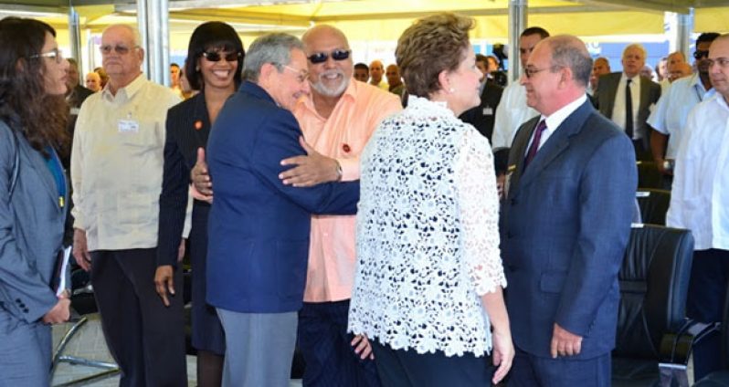 President Donald Ramotar and Cuba’s President Raul Castro embrace each other warmly at the opening of the Mariel Container Terminal