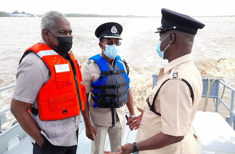 Minister of Home Affairs, Robeson Benn and Deputy Commissioner of Police, Operations, Clifton Hicken, in conversation with another senior officer of the GPF