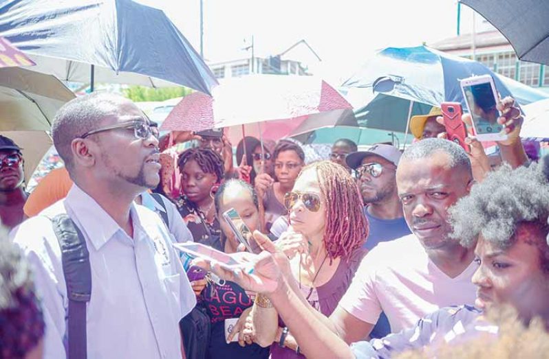GTU President Mark Lyte, (left) addressing his members last Thursday outside of the MoE building, after negotiations with the MoE fell through (Delano Williams photo)