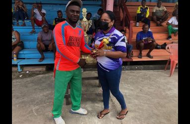 Player-of-the-match Mark Austin receives his trophy from Samantha Narine
