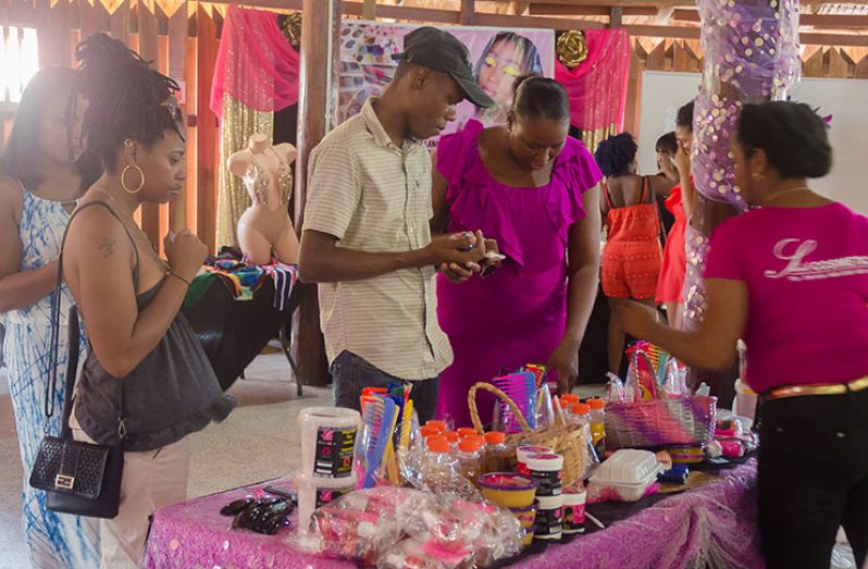 Patrons checking out haircare products at the Carnival Market held at the Umana Yana (Delano Williams photo)